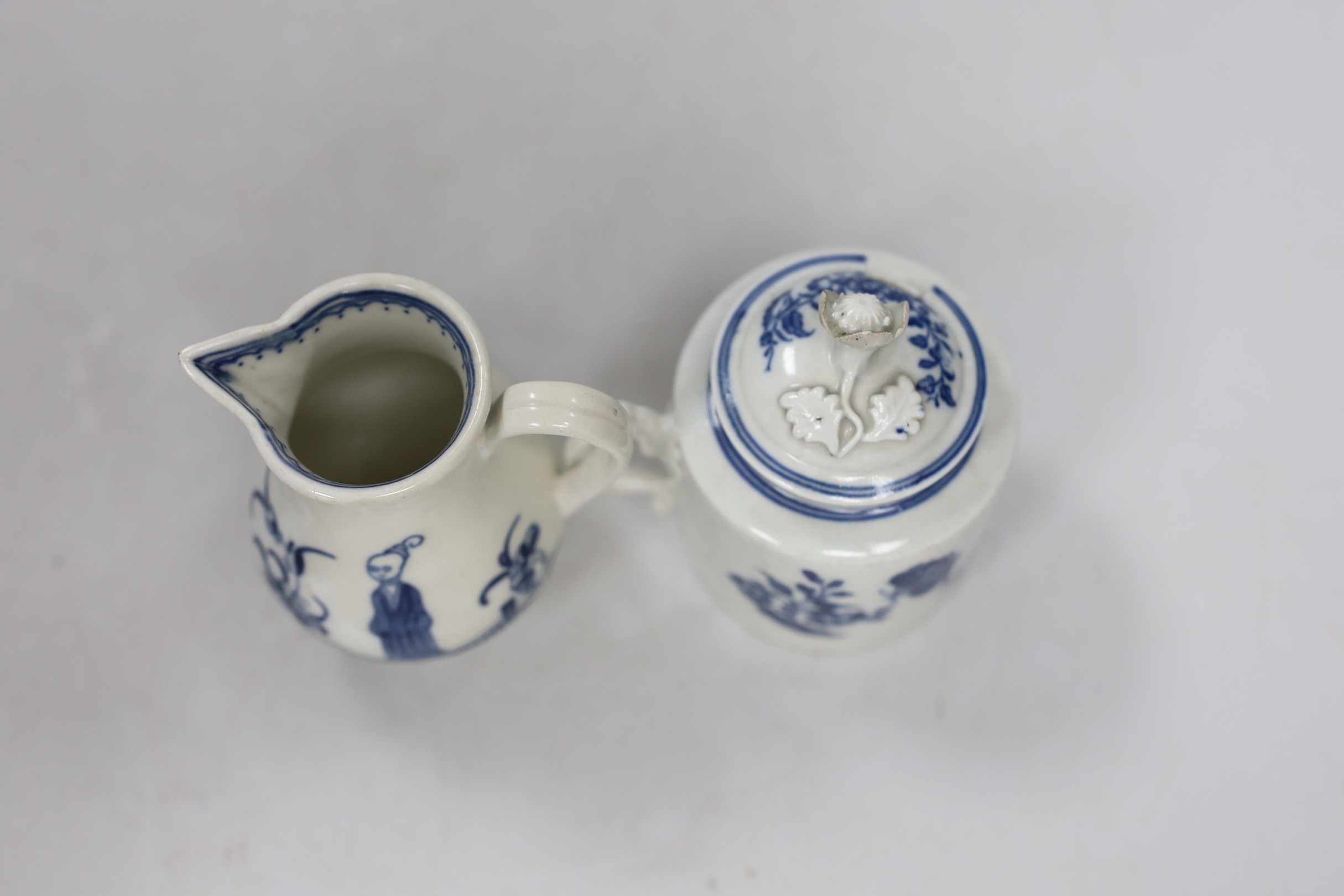 An 18th century Caughley rare sparrowbeak jug painted with the Waiting Chinaman pattern, handle repaired and a Caughley mustard pot and cover with Three Flowers, jug 9cms high